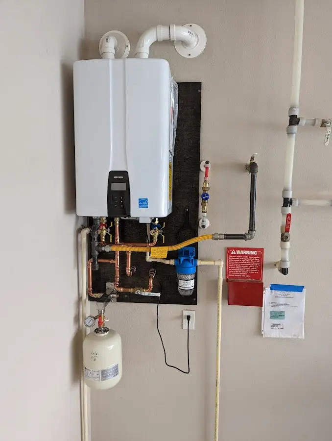 Professional plumber installing copper piping in a Spotsylvania Courthouse home